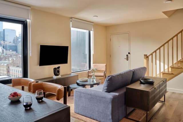 Spacious apartment living room with contemporary furnishings at Nester St. Lawrence Market in St. Lawrence Market, Toronto