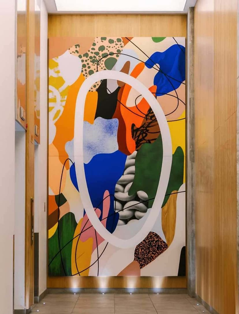 Vibrant exterior mural by Cyndie Belhumeur at Nester Downtown Montréal featuring circular forms and local cultural references